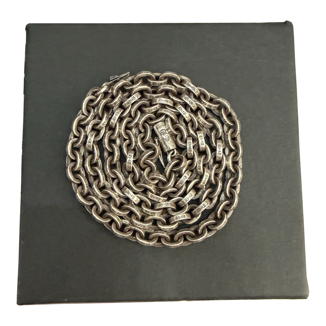 Chrome Hearts 20-inch Paper Chain necklace coiled on a black presentation box.