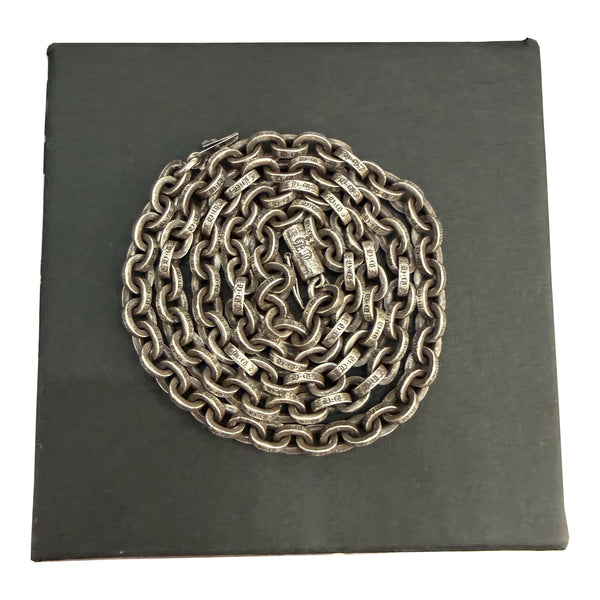 Chrome Hearts 20-inch Paper Chain necklace coiled on a black presentation box.